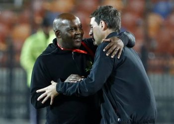 Ahly's Swiss manager Rene Weiler (R) is embraced by Mamelodi's South African manager Pitso Mosimane (L) during the first leg of the CAF Champions League Quarter-final football match between Egypt's Al-Ahly and South Africa's Mamelodi Sundowns at al-Ahly Stadium in the capital Cairo on February 29, 2020. (Photo by Khaled DESOUKI / AFP)