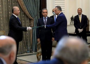 A handout picture released by the media office of the Iraqi Presidency on April 9, 2020 shows President Barham Saleh (L) swearing in spy chief Mustafa Kadhemi as new prime minister-designate. - Iraqi President Barham Saleh nominated spy chief Mustafa Kadhemi today as the country's third prime minister-designate this year, moments after predecessor Adnan Zurfi ended his bid to form a government. (Photo by - / IRAQI PRESIDENCY / AFP) / === RESTRICTED TO EDITORIAL USE - MANDATORY CREDIT "AFP PHOTO / HO / IRAQI PRESIDENCY MEDIA OFFICE" - NO MARKETING NO ADVERTISING CAMPAIGNS - DISTRIBUTED AS A SERVICE TO CLIENTS ===