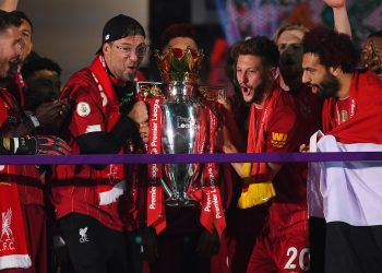Soccer Football - Premier League - Liverpool v Chelsea - Anfield, Liverpool, Britain - July 22, 2020 Liverpool manager Juergen Klopp with his players celebrate with the trophy after winning the Premier League Pool via REUTERS/Laurence Griffiths EDITORIAL USE ONLY. No use with unauthorized audio, video, data, fixture lists, club/league logos or 'live' services. Online in-match use limited to 75 images, no video emulation. No use in betting, games or single club/league/player publications.  Please contact your account representative for further details.