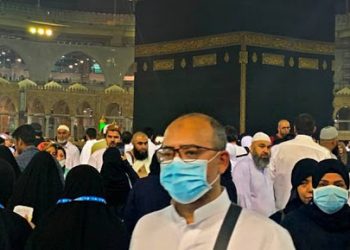 Muslim worshippers wearing protective face masks walk in the sahn (mosque courtyard) surrounding the Kaaba, Islam's holiest shrine, at the Grand Mosque complex in Saudi Arabia's holy city of Mecca on February 27, 2020. - Saudi Arabia on February 27 suspended visas for visits to Islam's holiest sites for the "umrah" pilgrimage, an unprecedented move triggered by coronavirus fears that raises questions over the annual hajj. The kingdom, which hosts millions of pilgrims every year in the cities of Mecca and Medina, also suspended visas for tourists from countries affected by the virus as fears of a pandemic deepen. (Photo by Haitham EL-TABEI / AFP) (Photo by HAITHAM EL-TABEI/AFP via Getty Images)