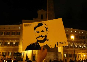 A man holds a placard during a vigil to commemorate Giulio Regeni, who was found murdered in Cairo a year ago, in downtown Rome, Italy January 25, 2017. REUTERS/Alessandro Bianchi