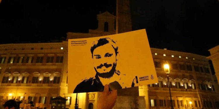A man holds a placard during a vigil to commemorate Giulio Regeni, who was found murdered in Cairo a year ago, in downtown Rome, Italy January 25, 2017. REUTERS/Alessandro Bianchi