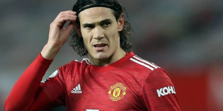 (FILES) In this file photo taken on December 29, 2020 Manchester United's Uruguayan striker Edinson Cavani is pictured during the English Premier League football match against Wolverhampton Wanderers at Old Trafford in Manchester, north west England. - The Uruguayan Football Players' Association (AFU) launched a scathing attack on the English Football Association (FA) on January 4, 2021 for banning Manchester United striker Edinson Cavani over a social media post the governing body ruled was in breach of anti-racism rules. In a lengthy statement the AFU accused the FA themselves of racism for not acknowledging the context in which the post was sent. (Photo by Martin Rickett / POOL / AFP) / RESTRICTED TO EDITORIAL USE. No use with unauthorized audio, video, data, fixture lists, club/league logos or 'live' services. Online in-match use limited to 120 images. An additional 40 images may be used in extra time. No video emulation. Social media in-match use limited to 120 images. An additional 40 images may be used in extra time. No use in betting publications, games or single club/league/player publications. /