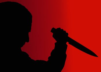 shadow man with knife on red background