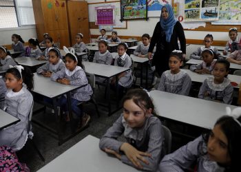 Students sit at their class on the first day of the new school year at the United-Nation run Elementary School at the Shati refugee camp in Gaza City, Saturday, Aug. 8, 2020. Schools run by both Palestinian government and the U.N. Refugee and Works Agency (UNRWA) have opened almost normally in the Gaza Strip after five months in which no cases of community transmission of the coronavirus had been recorded. (AP Photo/Adel Hana)