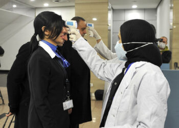 Egyptian Quarantine Authority employees scan body temperature for incoming flight attendants at Cairo International Airport on February 1, 2020, amidst efforts to detect possible cases of SARS-like "Wuhan coronavirus" (novel coronavirus 2019-nCoV). (Photo by - / AFP) (Photo by -/AFP via Getty Images)