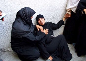 A female Palestinian relative weeps after receiving the news of the death of 22-year-old Saad Sabah in the morgue of the Kamal Adwan hospital in Beit Lahya in the northern Gaza Strip 01 August 2007. Israeli troops killed two Palestinians in the Gaza Strip during their latest incursion in the territory controlled by the Islamist movement Hamas, officials said. Gunfire exchanges erupted between the soldiers and militants after more than a dozen Israeli armoured vehicles and two bulldozers penetrated about 500 metres (yards) into the coastal strip near the northern town of Beit Lahiya, witnesses and medics said. (Photo/ Suhair Karam).