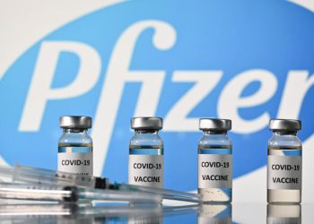 An illustration picture shows vials with Covid-19 Vaccine stickers attached and syringes with the logo of US pharmaceutical company Pfizer, on November 17, 2020. (Photo by JUSTIN TALLIS / AFP)